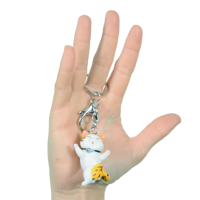 portada gato llavero blanco amarillo bailando plastico colgante metal