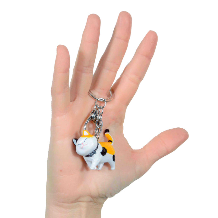 portada gato llavero negro amarillo blanco plastico colgante metal